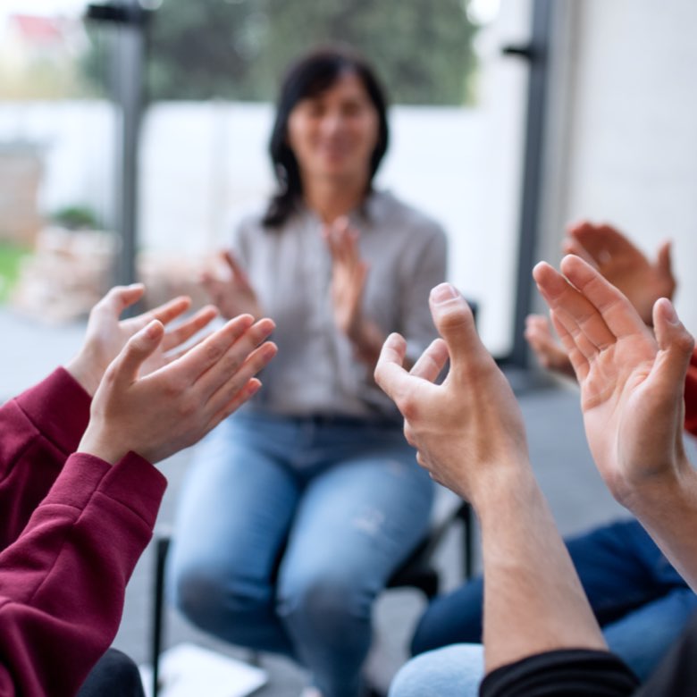 peers clapping in group therapy