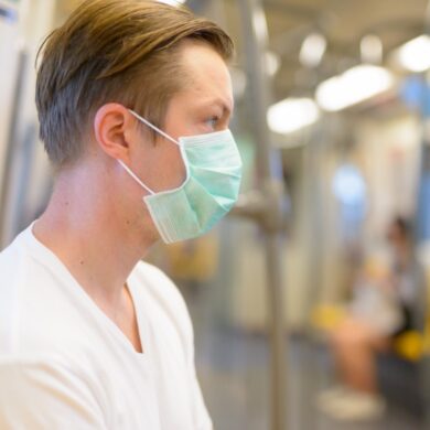 man wears mask on train