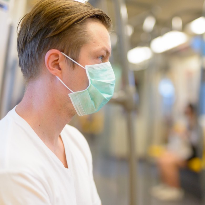 man wears mask on train