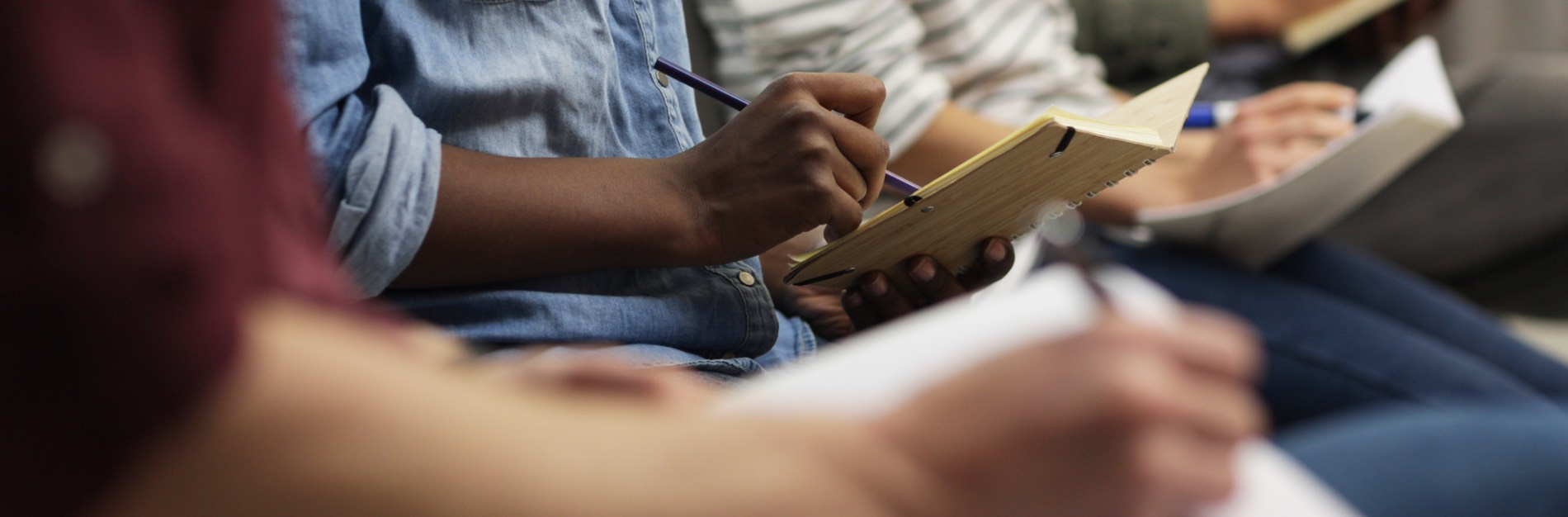 Detail of woman writing notes