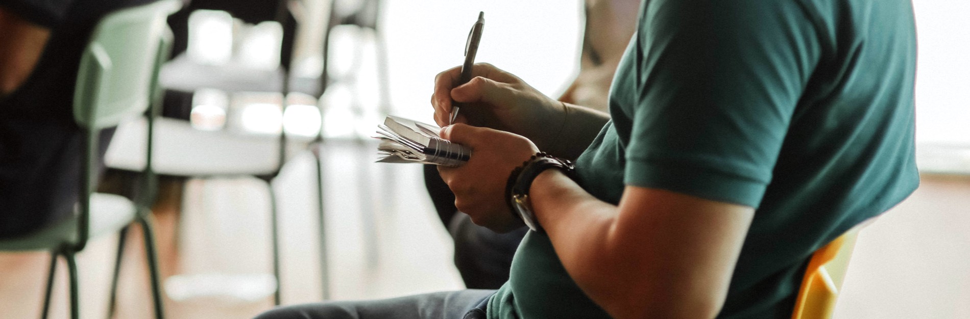 Detail of man taking notes