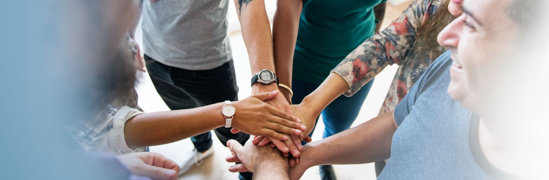 Team of hands stacked in huddle